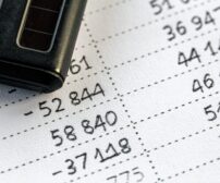 Calculator and numbers on paper close-up, the concept of budget planning, making money, tax calculations.