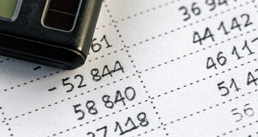 Calculator and numbers on paper closeup, finance concept. Calculator and numbers on paper close-up, the concept of budget planning, making money, tax calculations.